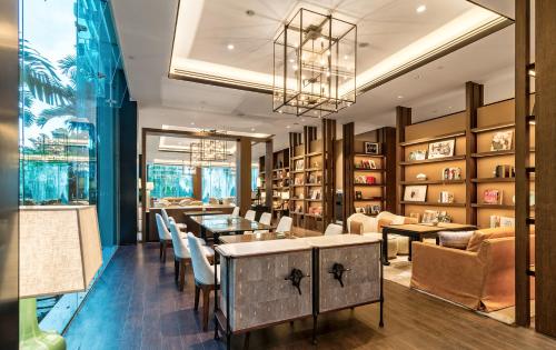 a restaurant with tables and chairs and bookshelves at Shangri-La Singapore in Singapore