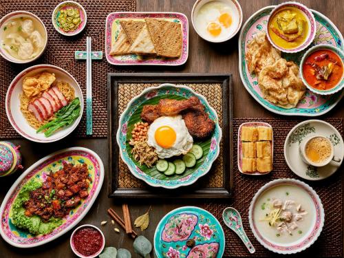 a table with plates of breakfast food on it at Shangri-La Singapore in Singapore