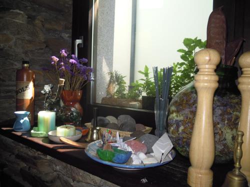 a shelf with candles and other items on it at Albergue O Durmiñento in Sarria