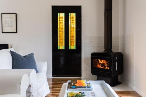 a living room with a fireplace and a stove at King Bed Studio in the Heart of Richmond in Richmond