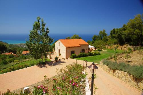 a house with a pathway in front of a building at B&B Le Ginestre in Cefalù