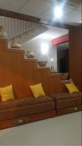 a mirror with a brown couch in front of a mirror at OUMAYA SAFA in Alger