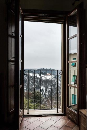 an open glass door with a view of a mountain at Casa Sirio in Palaia