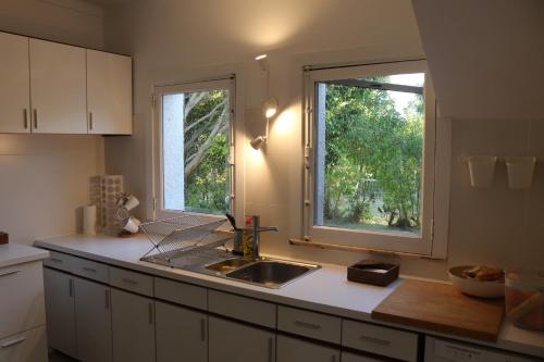 a kitchen with a sink and a window at Cabanas Jardim & Ria in Cabanas de Tavira