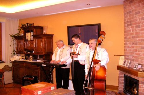 a group of men standing in a room with instruments at Penzion Andrej in Ružomberok