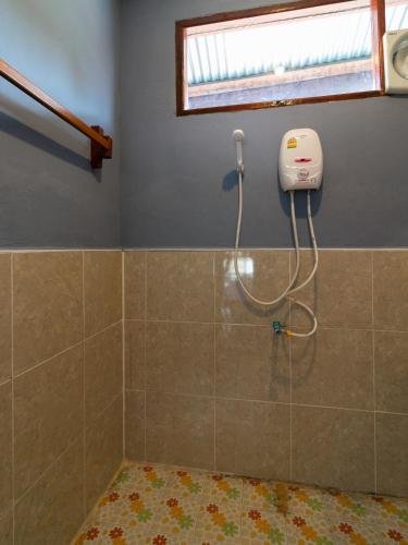 a shower in a bathroom with a window at Dokchampa Guesthouse in Ban Khon