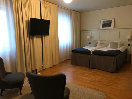 a hotel room with a bed and a television at Best Western Hotel Baltic in Sundsvall