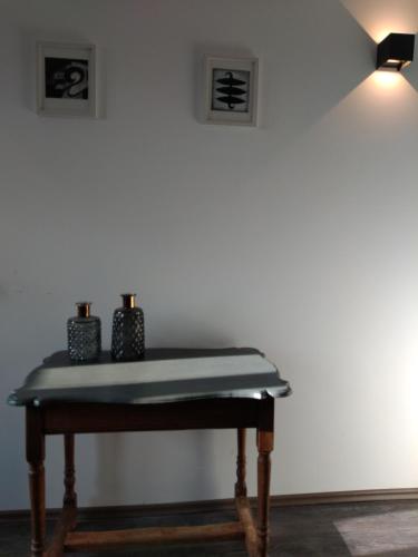a table with two candles on it next to a wall at Forester in Malmedy