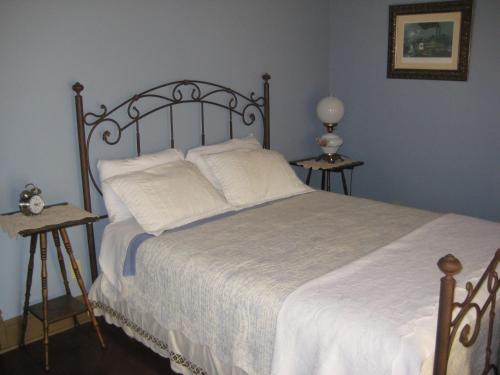 a bedroom with a large bed with white sheets at Backwoods Bed and Bath in McGregor