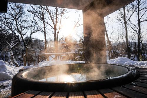 a hot tub with smoke coming out of it at Villa Helia in Dolný Kubín