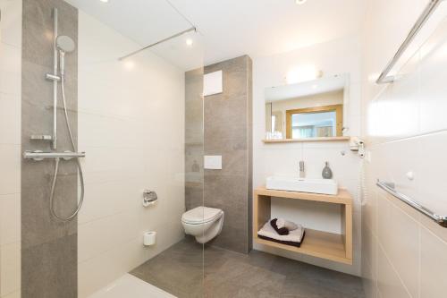uma casa de banho com um chuveiro, um WC e um lavatório. em Hieserhof em Neustift im Stubaital