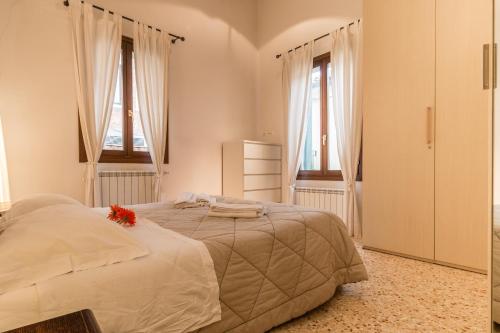 a bedroom with a large bed with flowers on it at Corderie de la Tana Biennale Exhibition @Arsenale in Venice