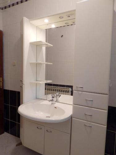 a bathroom with a sink and a mirror at APARTMANI MARIJA LJUBICA in Pag