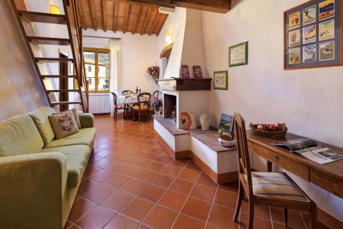 a living room with a couch and a fireplace at Agriturismo Fattoria Santo Stefano in Greve in Chianti