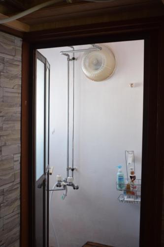 a shower in a bathroom with a glass door at Shoei backpackes hostel in Teshikaga