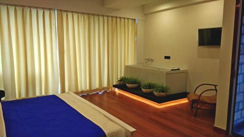 a bedroom with a bed and potted plants at Polo Cherrapunjee Resort in Cherrapunji