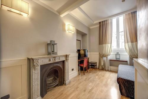 a living room with a fireplace and a chair at 939 Hotel in Rome