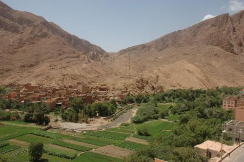 a village in a valley in the mountains at Riad Sephora in Tinerhir