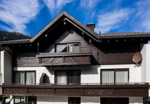 a house with a wooden roof at Haus 4 Montafon by Pferd auf Wolke in Gaschurn