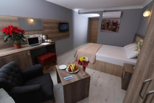 a small hotel room with a bed and a table with flowers at kocatepe hotel in Ankara