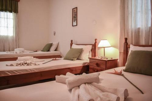 a bedroom with two beds with towels on the floor at Dream View Villa in Kipseli