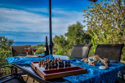 a table with a chess board on a blue table cloth at Dream View Villa in Kipseli