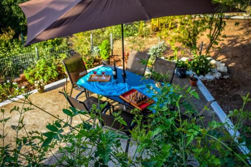 a blue table with chairs and an umbrella at Dream View Villa in Kipseli