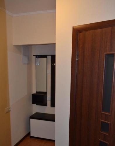 a small room with a door and a mirror at Соборная Апартаменты in Kamianets-Podilskyi