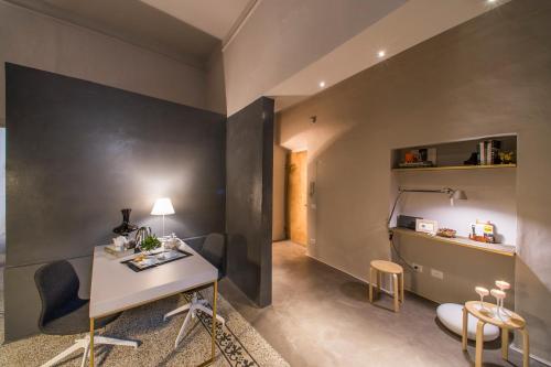 a room with a desk and chairs and a table at Palazzo del Papa in Siena