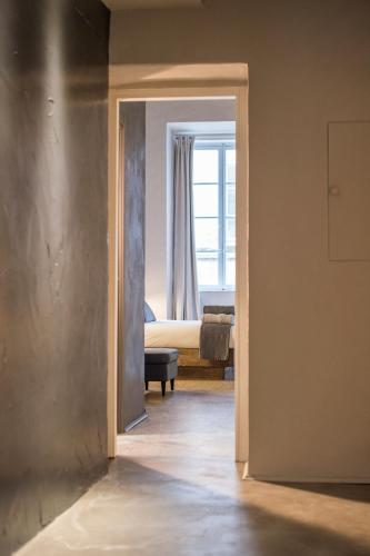 a view of a room with a bed through a doorway at Palazzo del Papa in Siena