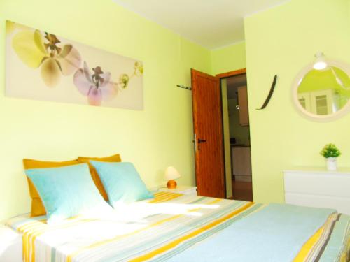 a bedroom with a bed with a flower on the wall at Pepita Penthouse with Terrace & WiFi, close to the Teresitas Beach in San Andrés