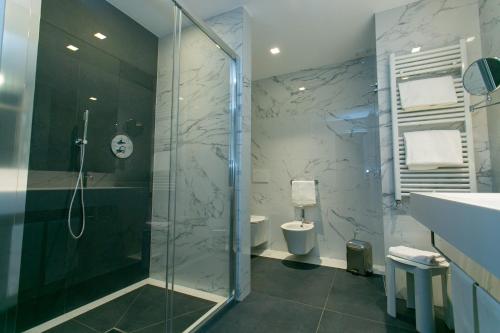 a bathroom with a glass shower and a toilet at Hotel Terme Venezia in Abano Terme