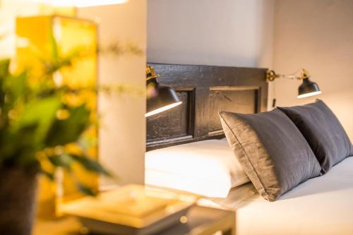 a bedroom with a bed with a mirror and a pillow at Palazzo del Papa in Siena
