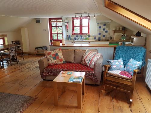 a living room with a couch and a table at Seren Loft - Cynghordy, Llandovery in Llandovery