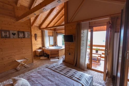 a bedroom with a bed and a television in a room at Villa Jelenic by Bertovic in Ogulin