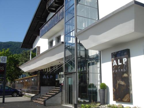 an office building with a glass facade and stairs at Alp Art Hotel Götzens in Innsbruck