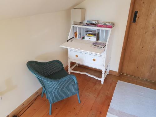 a desk and a chair in a room at Seren Loft - Cynghordy, Llandovery in Llandovery