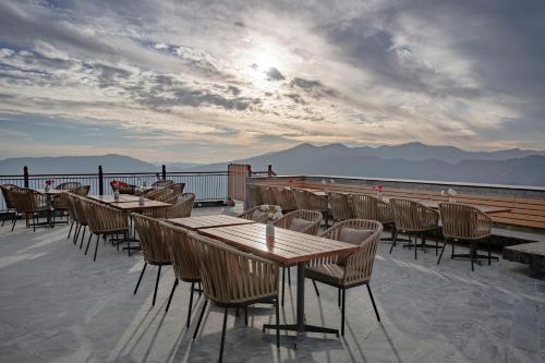 a row of tables and chairs on a roof at Taj Theog Resort & Spa Shimla in Shimla