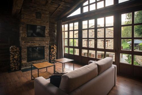 a living room with a couch and a fireplace at Complejo Rural Casona de Labrada in Labrada