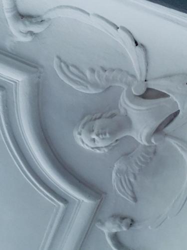 a white vase with a bird carved into it at Les Suites du Cours & Spa in Aix-en-Provence
