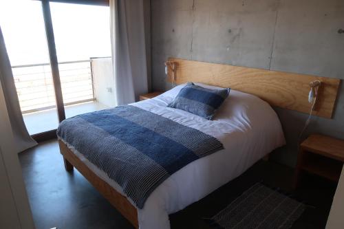 En eller flere senge i et værelse på Departamentos Kudun