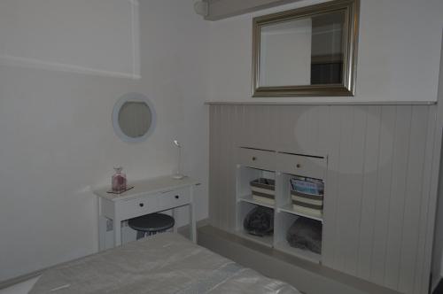 a bedroom with a bed and a desk and a mirror at Ground Floor City Retreat in Bath