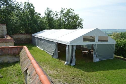 a large white tent on the grass in a yard at Stará Fara in Chržín