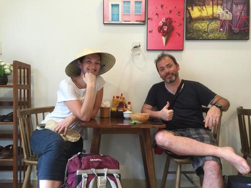 a man and a woman sitting at a table at candyinn in Hue