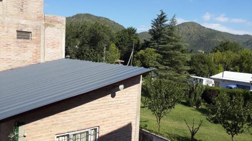a roof of a building with mountains in the background at Complejo "El Padrino" in Villa Carlos Paz