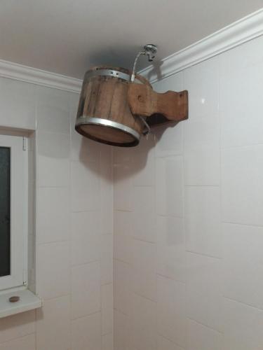 a light hanging from the ceiling in a bathroom at Hotel Dudarik in Kosiv
