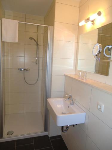 a bathroom with a shower and a sink and a shower at Pension Delia Will in Ahlbeck