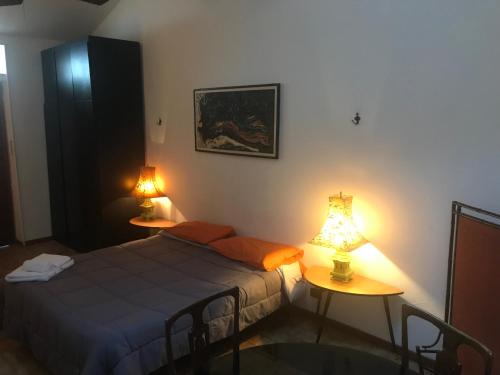 1 dormitorio con 1 cama y 2 mesas con lámparas en Mood-Cavour, en Pavia