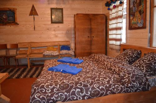a bedroom with a bed with blue pillows on it at Приватна садиба ''Світлиця гуцульщини" in Vorokhta