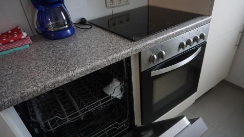 a black oven in a kitchen with a counter at Pension Turm in Schönwald